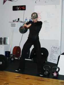 Pam swinging a 53lb kettlebell